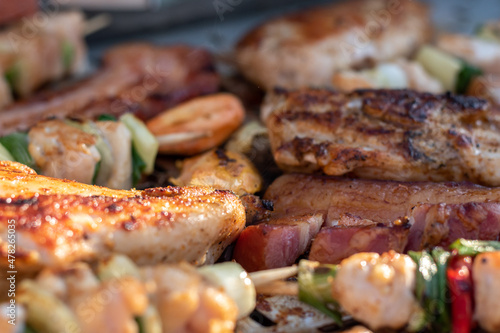 Chicken breast and pork meat pulled in wooden skewer with fresh colorful and tasty vegetables