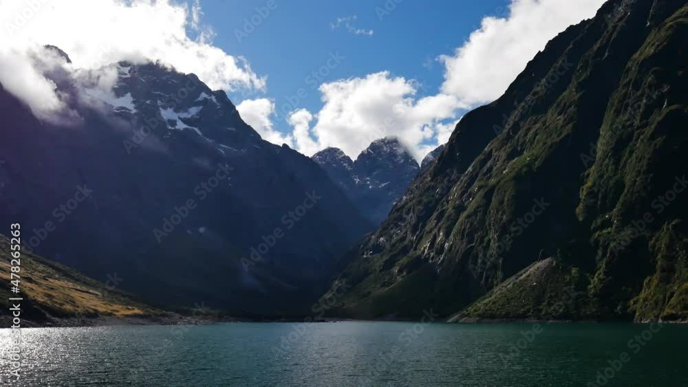 Time lapse shot of beautiful Lake Marian and flying clouds behind mountains in summer Time lapse shot of beautiful Lake Marian and flying clouds behind mountains in summer