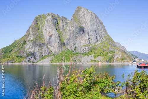 Amazing view of a norwegian beautiful nature and typical small fishing cabins on a sunny summer day over the fjords