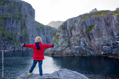 People, enjoying beautiful view of norwegian mountains near A village on a sunny evening, Lofoten, Norway photo