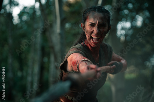 Aggressive woman attacking with spear and shield photo