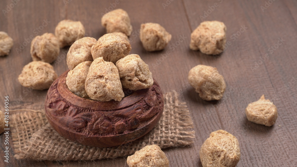 Raw soya chunks on dark background. Healthy, nutritious soybean meat, chunks isolated.Vegan food concept.
Raw soya chunks on dark background. Healthy, nutritious soybean meat, chunks isolated.Vegan food concept.