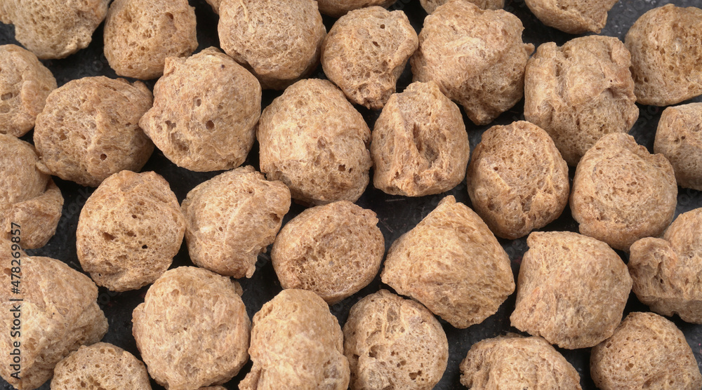 Raw soya chunks on dark background. Healthy, nutritious soybean meat, chunks isolated.Vegan food concept. Raw soya chunks on dark background. Healthy, nutritious soybean meat, chunks isolated.Vegan food concept.