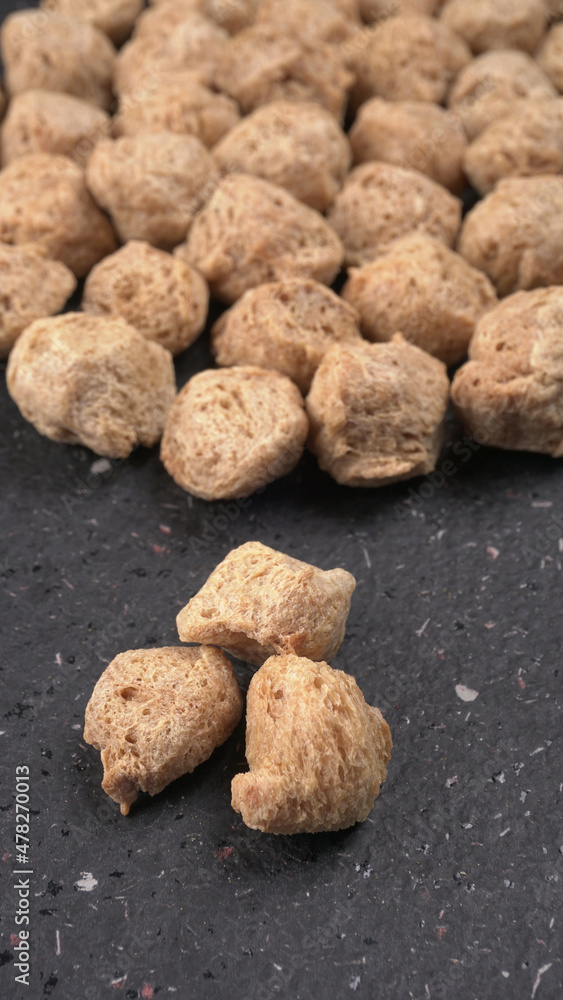 Raw soya chunks on dark background. Healthy, nutritious soybean meat, chunks isolated.Vegan food concept. Raw soya chunks on dark background. Healthy, nutritious soybean meat, chunks isolated.Vegan food concept.