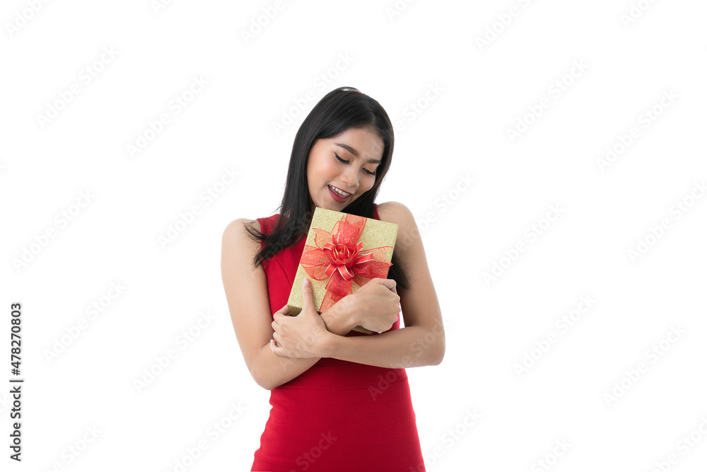 Happy beautiful young Asian woman in casual business red dress is holding, hugging gold gifts boxes with red ribbon, close eyes with copy space, isolated white background texture. With clipping path. Happy beautiful young Asian woman in casual business red dress is holding, hugging gold gifts boxes with red ribbon, close eyes with copy space, isolated white background texture. With clipping path.