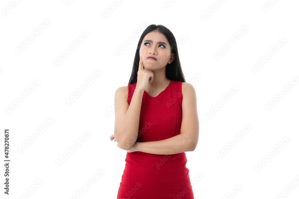 Portrait of beautiful young Asian woman in casual business red dress is looking up, pointing cheek and crossed arm while thinking, imagine something, isolated white background with clipping path. Portrait of beautiful young Asian woman in casual business red dress is looking up, pointing cheek and crossed arm while thinking, imagine something, isolated white background with clipping path.
