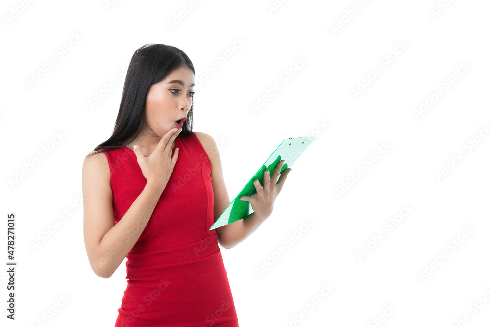 Happy beautiful young Asian business woman in casual business red dress is looking green clipboard with feels surprised on her paper work or project on board, isolated white background. Clipping path Happy beautiful young Asian business woman in casual business red dress is looking green clipboard with feels surprised on her paper work or project on board, isolated white background. Clipping path