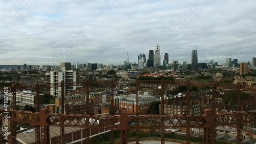 Ariel view of the Bethnal Green gas holder in East London with the cloudy city of London skyline