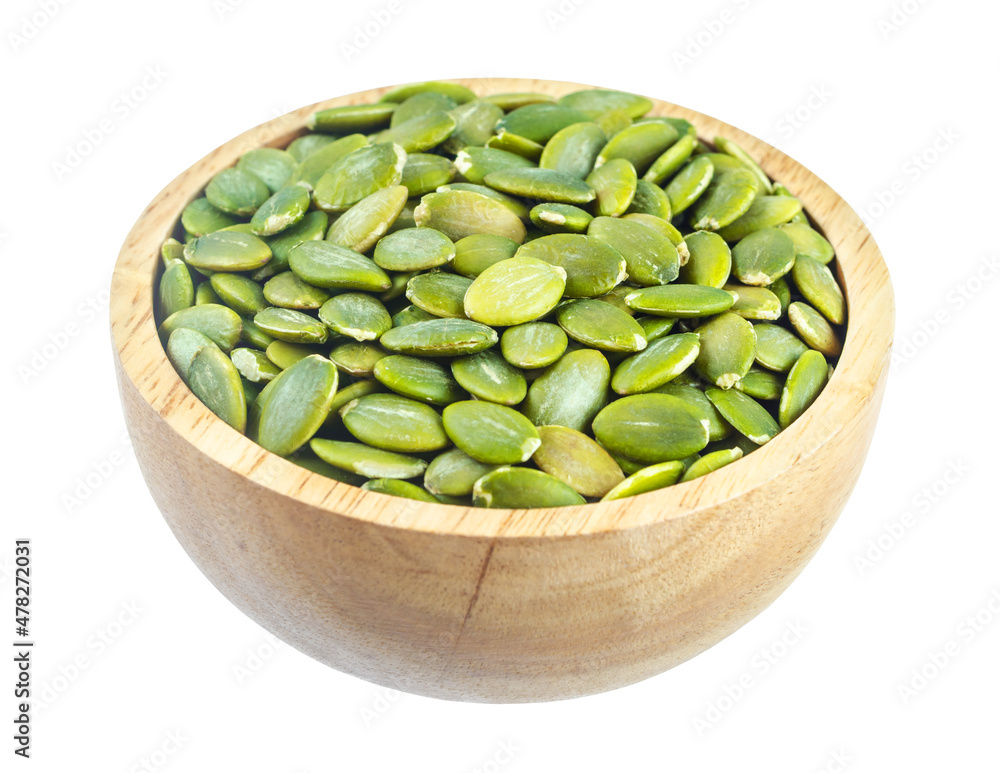 Pumpkin seeds green peeled in wooden bowl isolated on white background. Pumpkin seeds green peeled in wooden bowl isolated on white background.