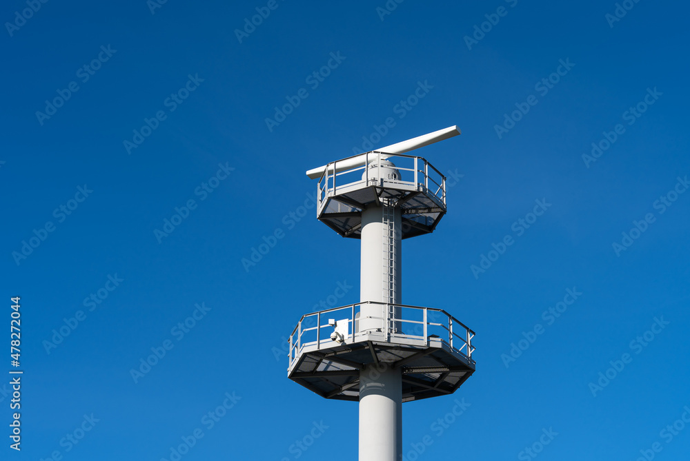 A radar for traffic control near a seaport on a clear day. A radar for traffic control near a seaport on a clear day.