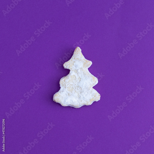 Christmas tree made of cookies decoration against purple background. Minimal Holiday food concept. Creative New Year's background