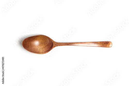 Wooden spoon on a white background top view.