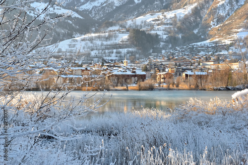 фотографія view of a city of Savoy, Bourg Saint Maurice,  on the banks of a river with froz