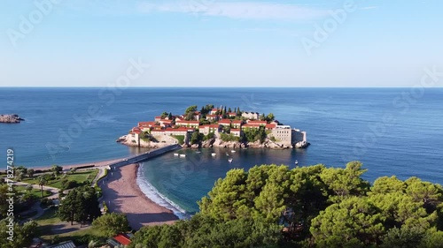 Amazing aerial view of sea island with old architecture buildings in one of the South countries. It's connected to the mainland with stone bridge. Drone Shot of Sveti Stefan (Saint Stephen)in