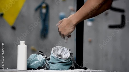 male hand using magnesium powder before climbing practice