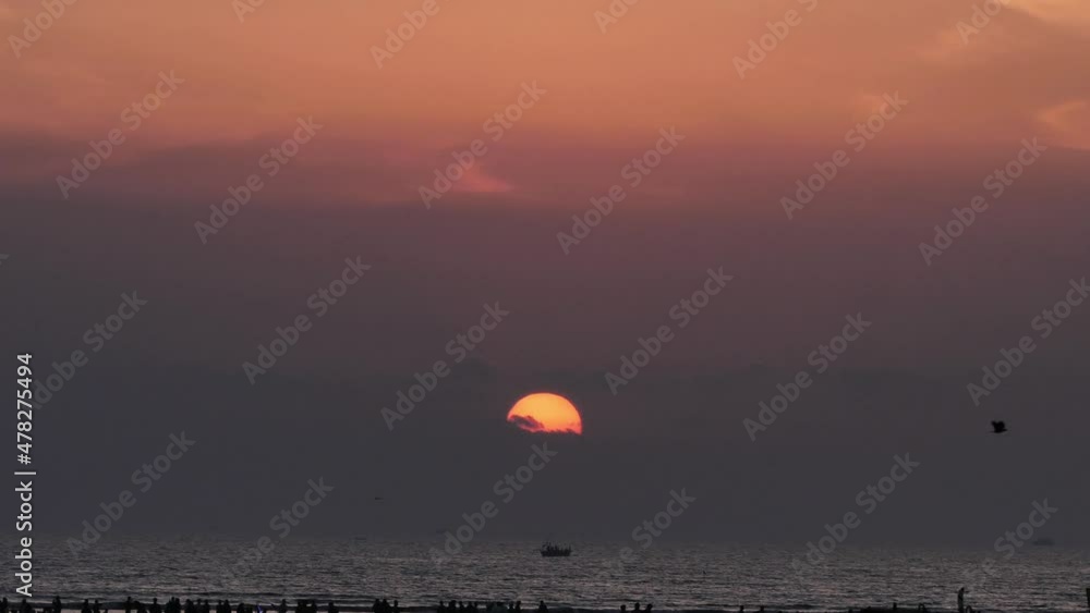 Orange Sun and Sunset Skies Slow Zoom Out Reveal Of Silhouette Of People On Karachi Beach Orange Sun and Sunset Skies Slow Zoom Out Reveal Of Silhouette Of People On Karachi Beach