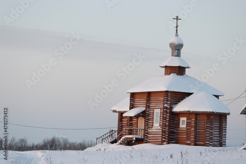 wooden church in the village in winter