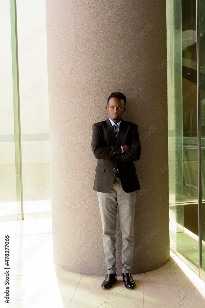 Portrait of African businessman wearing suit and tie outdoors in city Portrait of African businessman wearing suit and tie outdoors in city