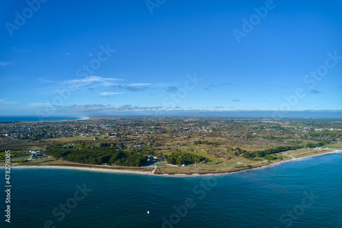 Aerial view of a french city on the atlantic ocean. Water edge on the beach. Blue sky for copy space. France, Brittany, Penmarch. photo