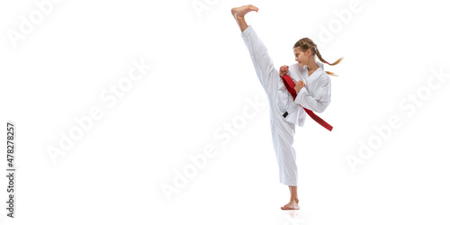 Flyer. Portrait of young girl, teen, taekwondo athlete practicing alone isolated over white background. Concept of sport, education, skills
