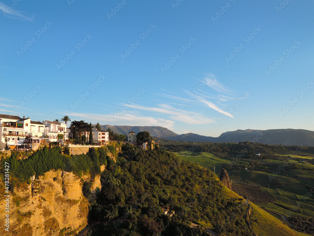 Rhonda. Spain. Andalusia. Old city. Puento nuevo. Sunset over green hills and white houses.