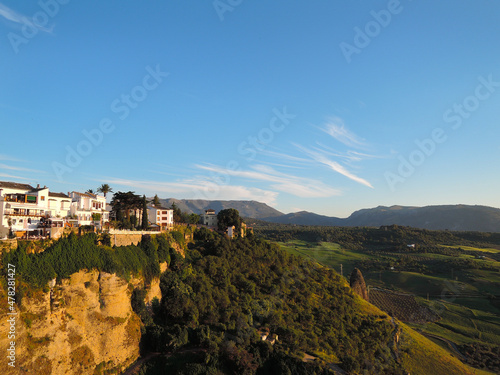 Rhonda. Spain. Andalusia. Old city. Puento nuevo. Sunset over green hills and white houses.