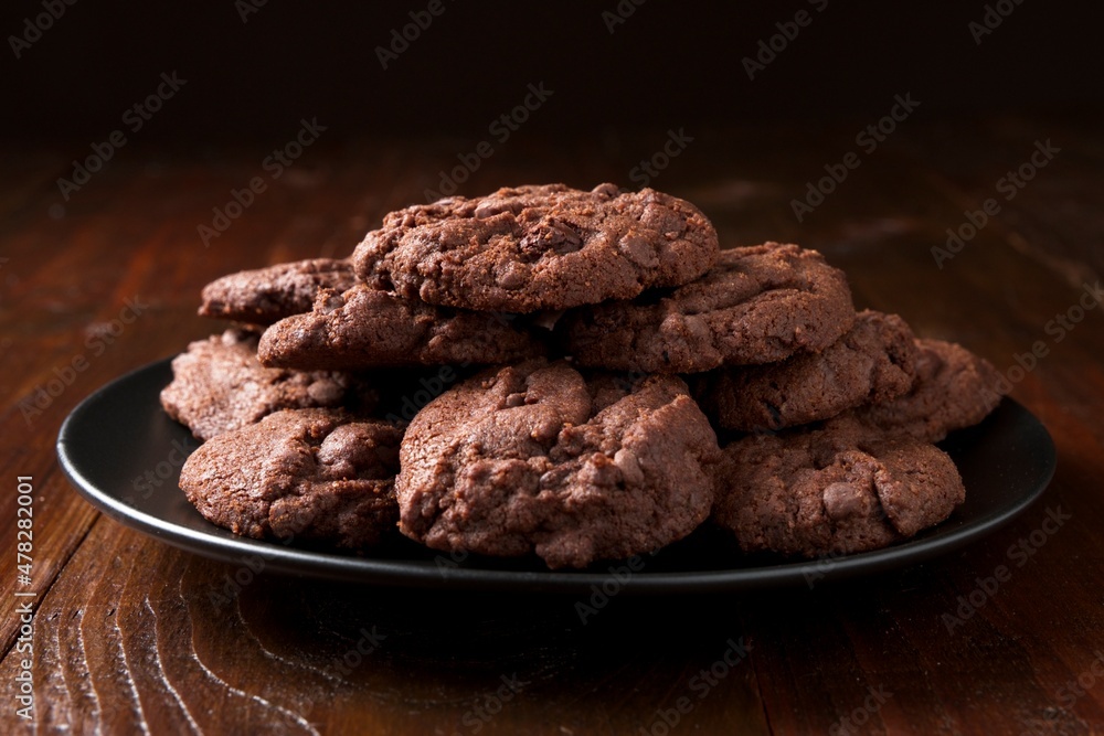 Close-up of a black plate with homemade triple chocolate chip cookies Close-up of a black plate with homemade triple chocolate chip cookies