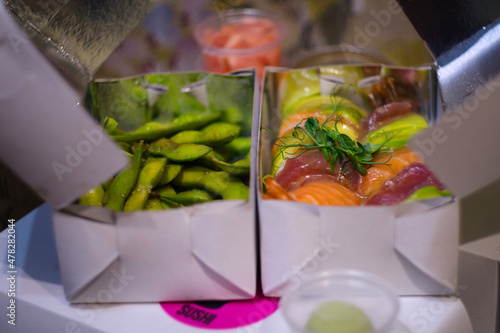 Traditional Jepanese sushi, edamame beans and rolls in paper box for take away and delivery photo