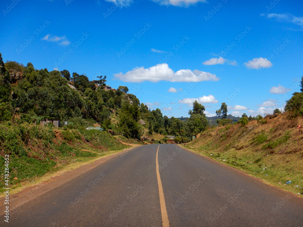 Scenic view of an empty highway against trees in Iten, Rift Valley, Kenya Scenic view of an empty highway against trees in Iten, Rift Valley, Kenya