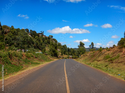Scenic view of an empty highway against trees in Iten, Rift Valley, Kenya