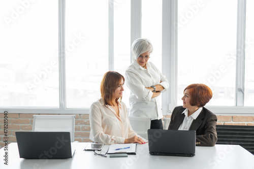 working for a laptop successful females in the office