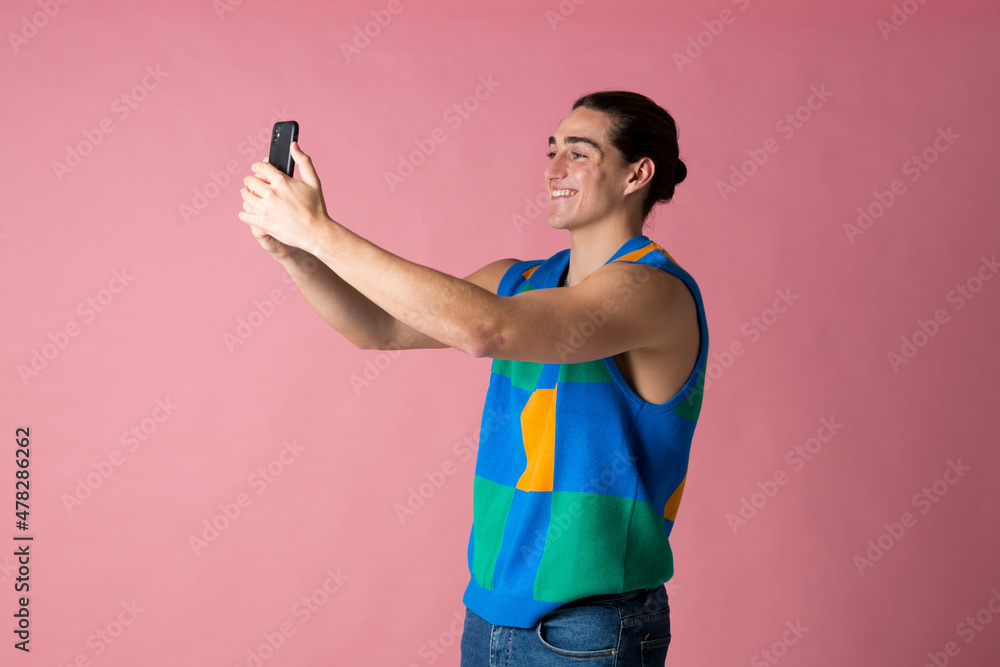 Model taking a selfie with her cell phone Videoconferencing at work or with a friend Model taking a selfie with her cell phone Videoconferencing at work or with a friend