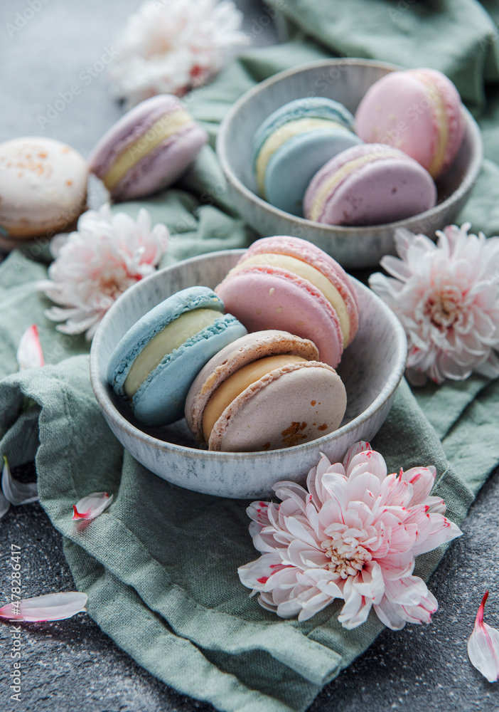 Beautiful colorful tasty macaroons on a concrete background
