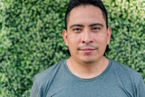 Hispanic man in a gray t-shirt, looks into the camera for a photo