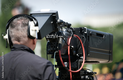 Camera operator working with a broadcasting television camera during a live event