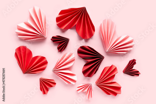 Paper hearts on pink background. Symbol of love for valentines day  happy birthday  greetings  Mothers day  Women s day. Origami.