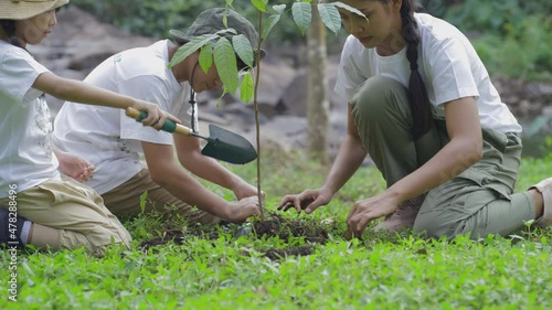 Volunteer Asian and children planting a forest as save world concept. Activities aimed at instilling a sense of reverence for the natural world and the environment