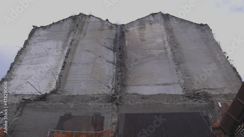 Facade of a building under construction.
Abandoned building site.
Tilt up shot.