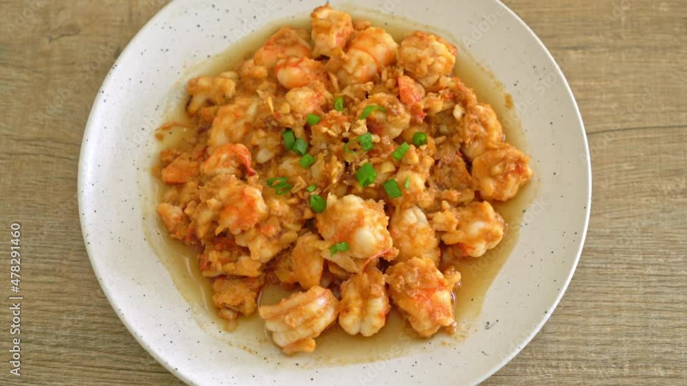 stir-fried shrimps with garlic and shrimps paste on whie plate stir-fried shrimps with garlic and shrimps paste on whie plate