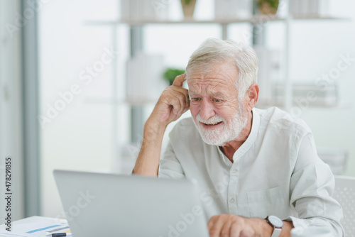 The senior elderly man work from home get confuse from work in a workplace room.