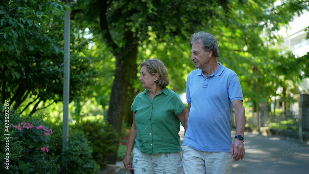older couple walking together, senior people relationship outside in day walk
