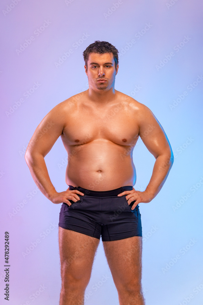 Fototapeta premium A very fat man want to lose weight and become a slim athlete. Fitness concept.