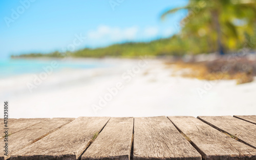 Wooden table top for product placement in front of beautiful tropical beach