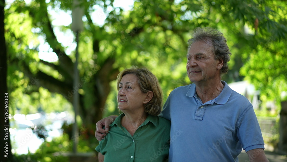 Happy senior couple walking together in afternoon walk Happy senior couple walking together in afternoon walk