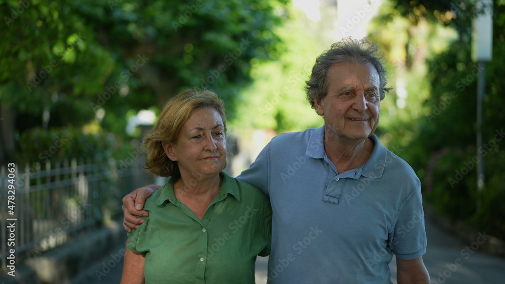 Happy senior couple walking together in afternoon walk Happy senior couple walking together in afternoon walk