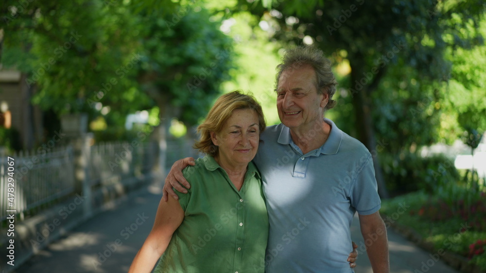 Fototapeta premium Happy senior couple walking together in afternoon walk