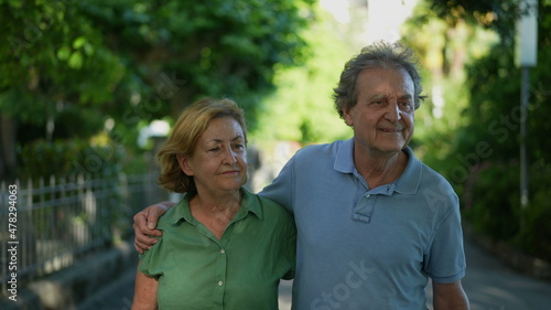 Happy senior couple walking together in afternoon walk