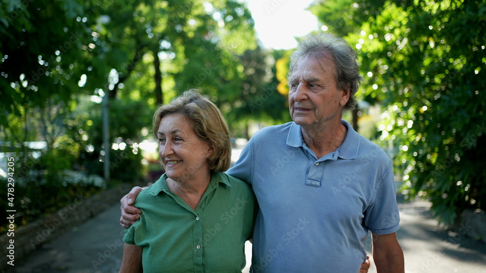 Happy senior couple walking together in afternoon walk Happy senior couple walking together in afternoon walk
