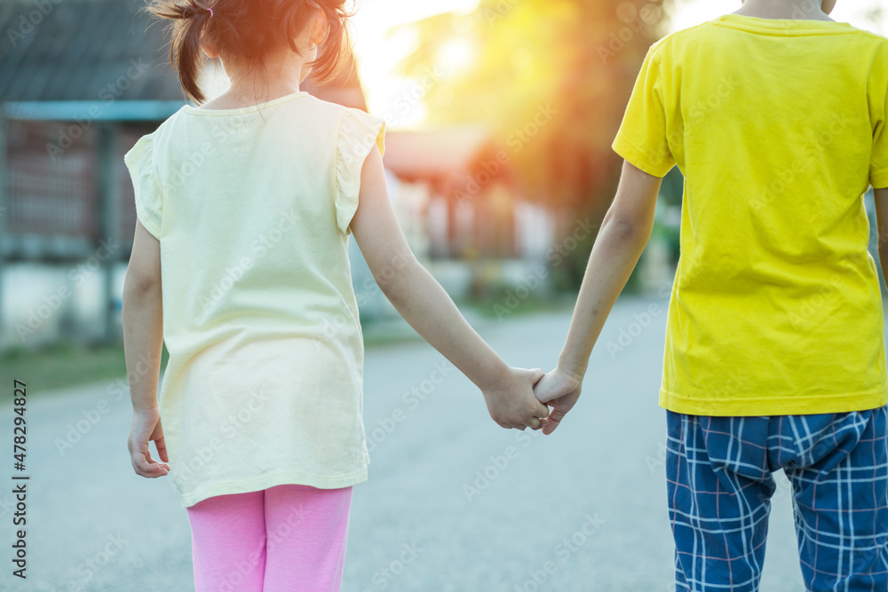 parent holds the hand of a small child parent holds the hand of a small child