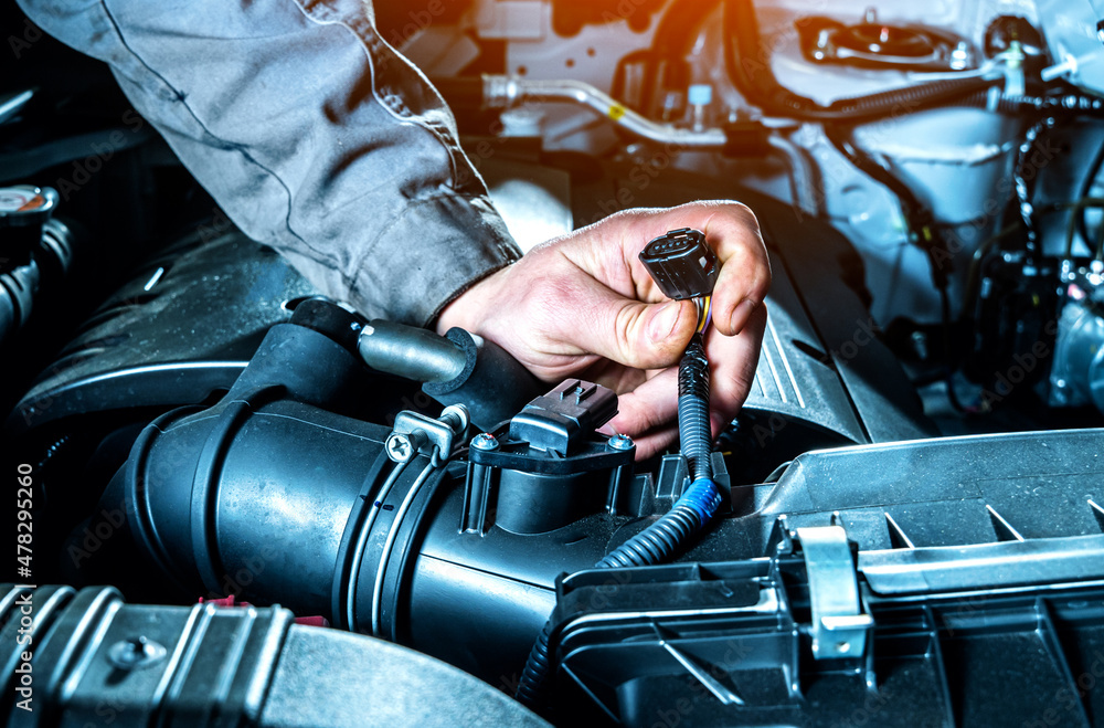 Mass air flow sensor checking close up. Car diagnostics in auto service